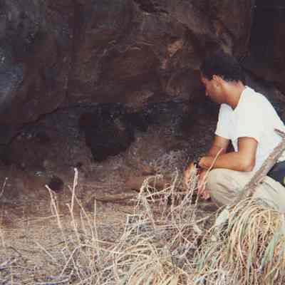 Unidentified man examining arch site