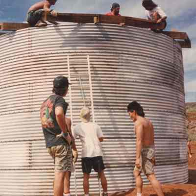 Men working at a water catchment structure