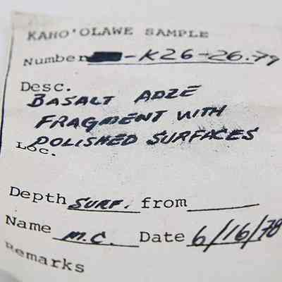 Artifact slip for a basalt adze fragment: The image shows a label for a sample from Kahoʻolawe, designated K26-26.79, describing a basalt adze fragment with polished edges.