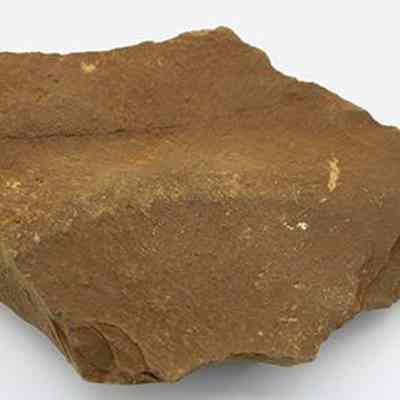 Basalt drill: The image shows a textured brown sandstone drill with rough, sharp edges, resting on a plain white background.