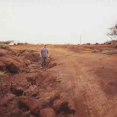Unidentified man next to dirt road