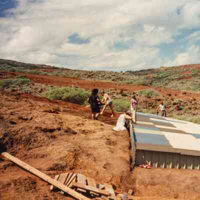 People constructing water catchment structure