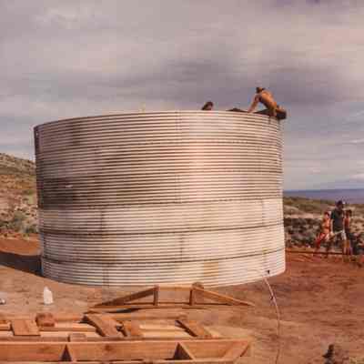People working on and around water catchment structure