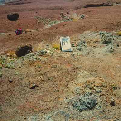 Hardpan terrain with white sign