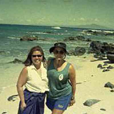 Two women on sandy white beach