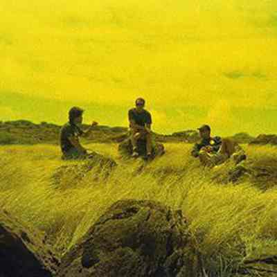 Three unidentified men sitting on pohaku (stones)