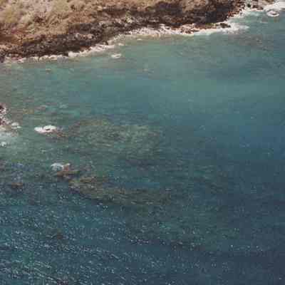 High aerial view of coral beds and bay near 'Oawapalua