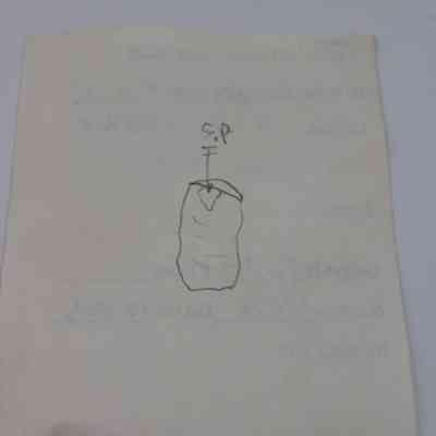 Back of artifact slip for basaltic glass flake: The image shows a paper slip with a hand-drawn sketch of an artifact, labeled with notes and some text.