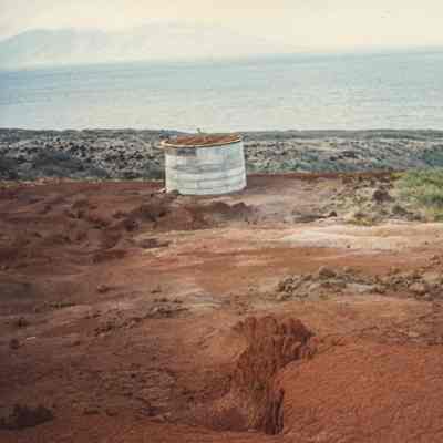 Metal water catchment on hardpan terrain