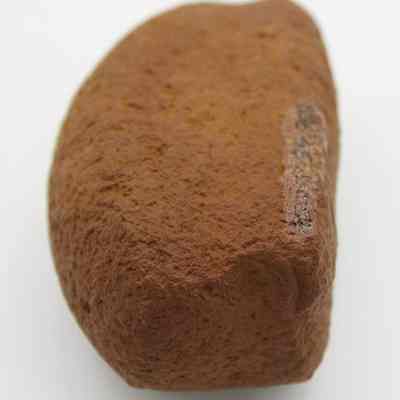 Lengthwise view of breadloaf sinker: The image shows a brown, oval-shaped stone sinker with a rough texture, designed to weigh down fishing lines in water.