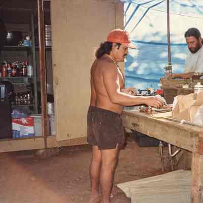 Two men working on piping