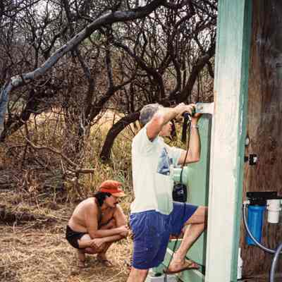 Two men working on water catchment