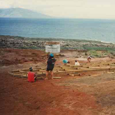 People working on wooden base frame