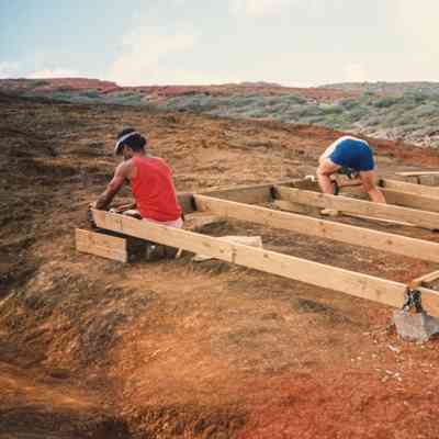 Men working on water catchment structure frame