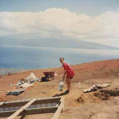 Person lifting a box near a water catchment structure