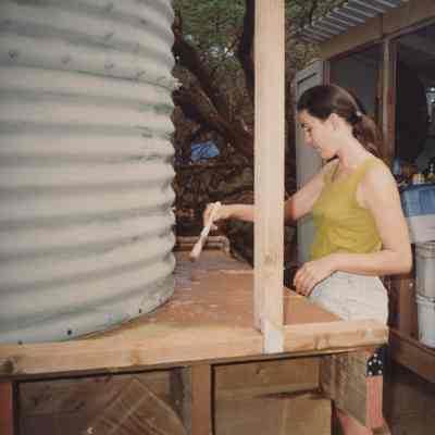 Woman painting water storage base