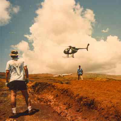 People awaiting load delivery from a helicopter