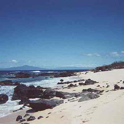White sandy beach with Maui in the background