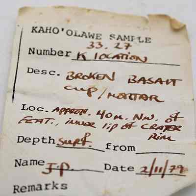 Artifact slip for cup fragment or mortar: The artifact slip provides details about a broken basalt cup or mortar, found approximately 40 meters northwest of a feature on Kaho'olawe.
