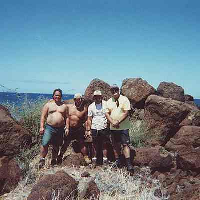 A group of men near pohaku (rocks)