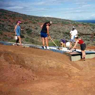 People working on water catchment structure