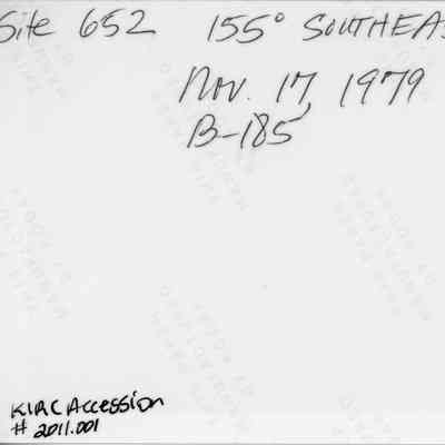 Back of midden scatter photo (KIRC Object ID #2011.001.195): The image shows handwritten text on photographic  paper, indicating "Site 652, 155° Southeast," dated "Nov. 17, 1979."