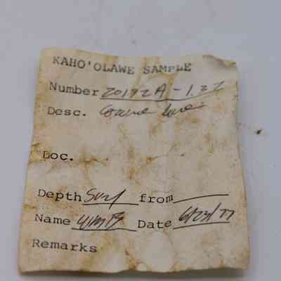 Artifact slip for cowrie shell lure: The image shows a weathered artifact slip from a Kaho'olawe sample, detailing the number, description, depth, and date.