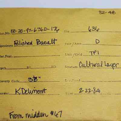 Artifact envelope for basalt piece: The image shows a yellow archaeological artifact envelope detailing a polished basalt specimen, found in site 636, recorded by K. Delimont.