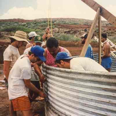 Men working on metal water catchment structure