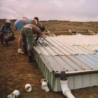 People working on a corner of a water catchment structure
