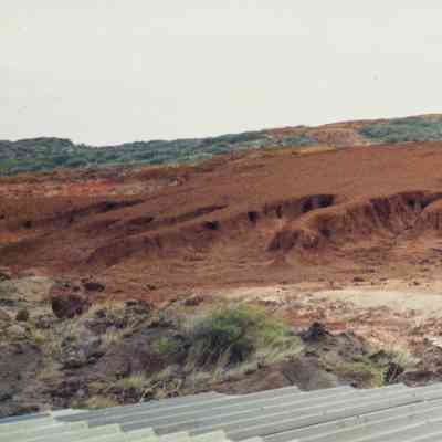 Three people talking overlooking hardpan