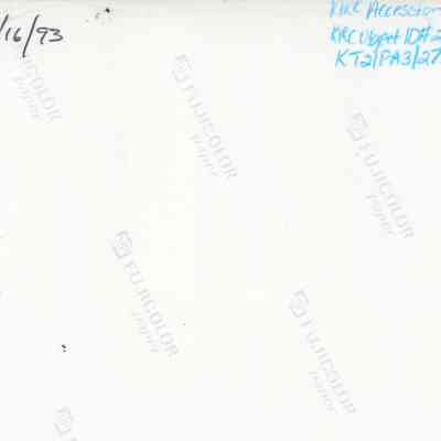 Back of photograph (KIRC Object ID #2013.019.525): The image is the back of a photograph, featuring handwritten notes and numbers in black and blue pencil with "FUJICOLOR paper" logos.