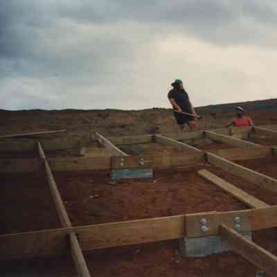 Two persons working at wooden frame