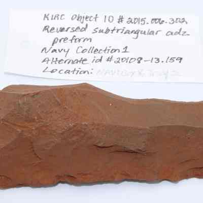 Reversed subtriangular adze preform with artifact slip: Origsize: 10.25 cm (L) x 4 cm; Origformat: Artifact; Resolution: 200 dpi