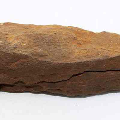 Profile of whetstone (hoana) fragments placed together: The image shows two rough, brown whetstone (hoana) fragments with cracked surfaces, stacked together forming one whetstone, lying against a plain, white background.