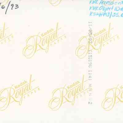 Back of photo (KIRC Object ID #2013.019.520): The image shows the back of a photograph with the Kodak Royal Paper logo repeatedly printed in yellow, along with handwritten numbers and dates on the surface.