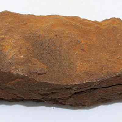Top view of whetstone (hoana) fragments placed together: The image shows fragments of a whetstone (hoana) with a rough, reddish-brown surface, likely used for sharpening tools.