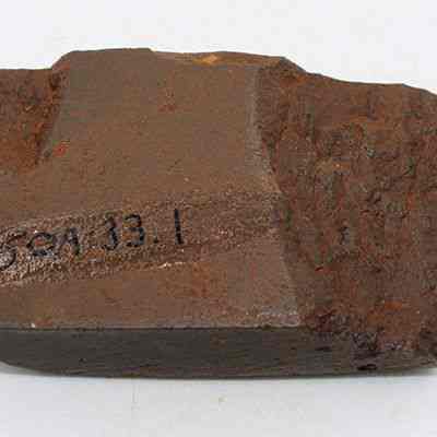 Adze fragment with alternate id number visible: The image shows a fragment of an adze, featuring a rough, uneven surface with engraved markings labeled "150A 33.1."