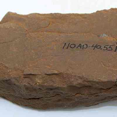 Whetstone (hoana) fragments placed together with alternate id number: The image shows fragments of a whetstone (hoana), featuring a rough, irregular shape with a notation marked on its surface indicating "110 AD-40.551."