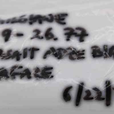 Artifact bag label for basalt adze blank: The image shows a plastic surface with black handwritten text, including a date.