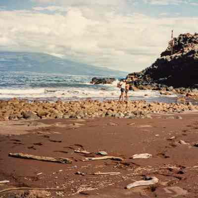 Two people at rocky shoreline