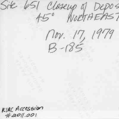 Back of midden deposit photo (KIRC Object ID #A2-4-9/4.8: The image shows a handwritten note detailing a closeup of a deposit at Site 651, angled 45 degrees northeast.