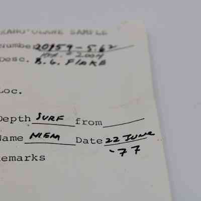 Artifact slip for basaltic glass flake: The artifact slip contains handwritten information, including a sample number, description, depth, name, and date of June 22, 1977.