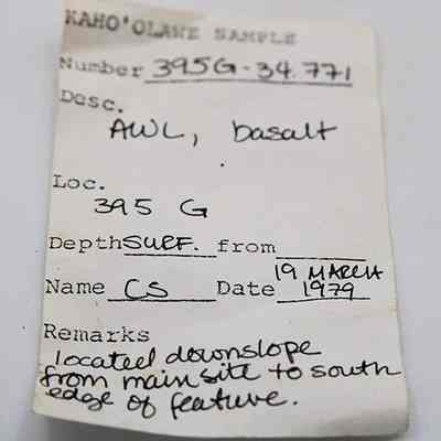 An artifact slip for awl: The image shows a labeled sample tag from Kaho'olawe, detailing "AWL, basalt" found at location "395 G," with remarks.
