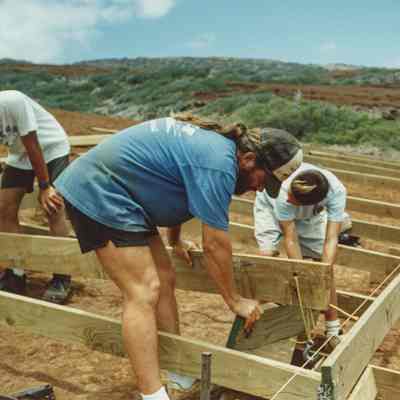 People working on wooden frame