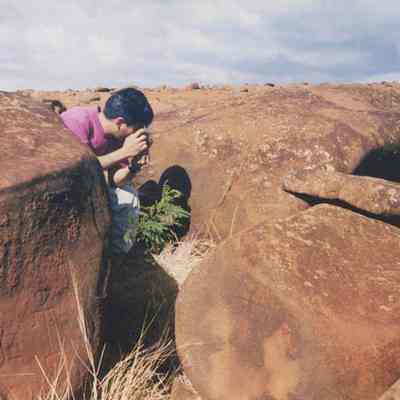 Person photographing petroglyphs