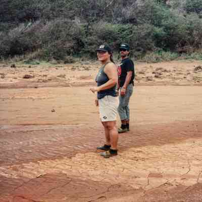 Two people standing on dry terrain