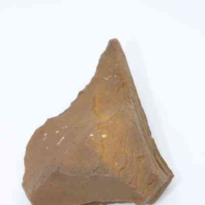 Lengthwise view of basalt awl (kui houhou): The image shows a rough, triangular basalt awl with uneven surfaces, designed for piercing or engraving, resting against a white background.