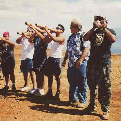 Men blowing pu and pu ohe