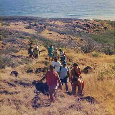 Group of people hiking up a trail